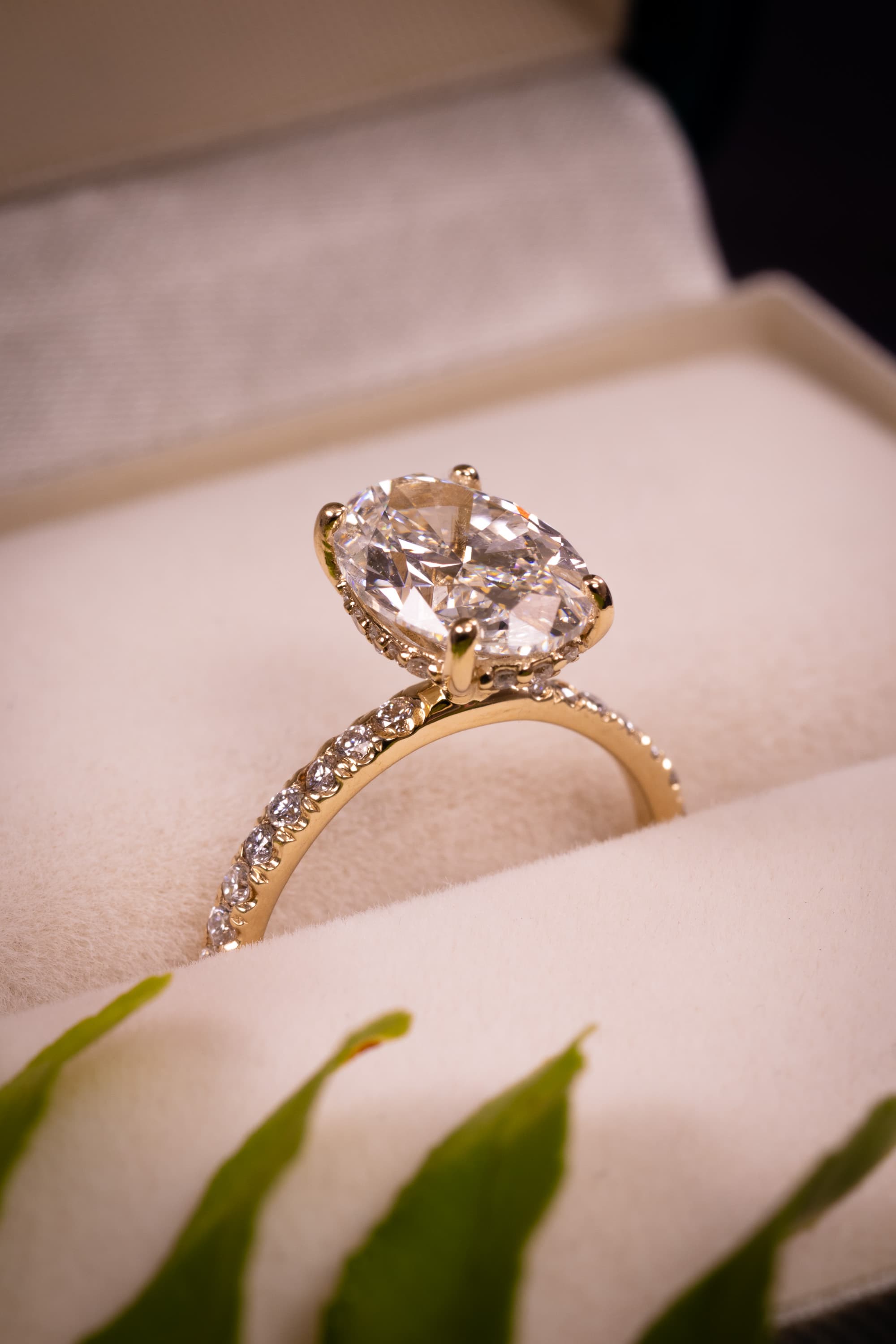 A modern minimalist yellow gold solitaire holding an old-cut diamond