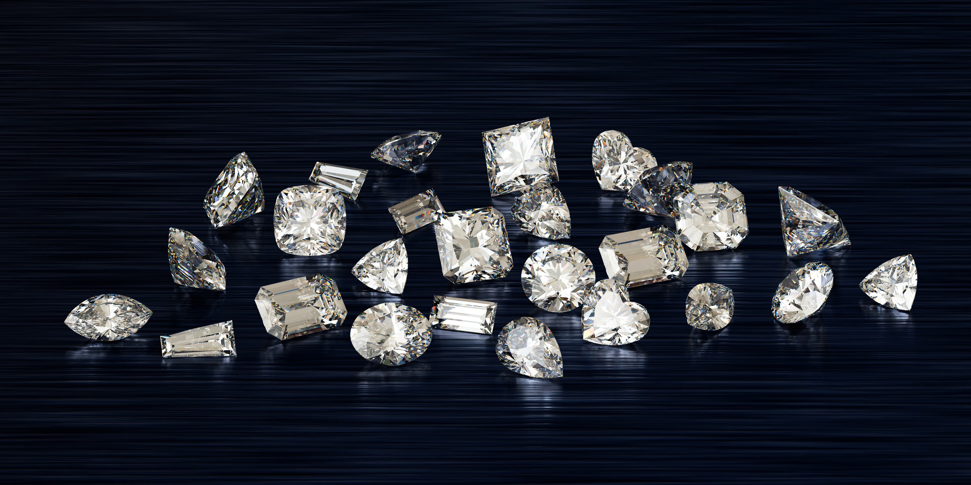 A row of five loose round diamonds in ascending size showing carat-weight progression