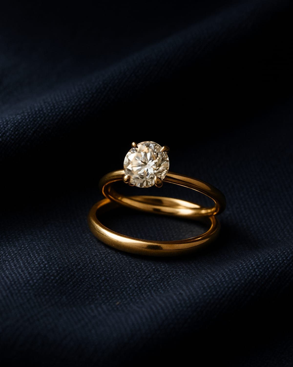 A yellow gold engagement ring nested together with a matching yellow gold wedding band as a bridal pair