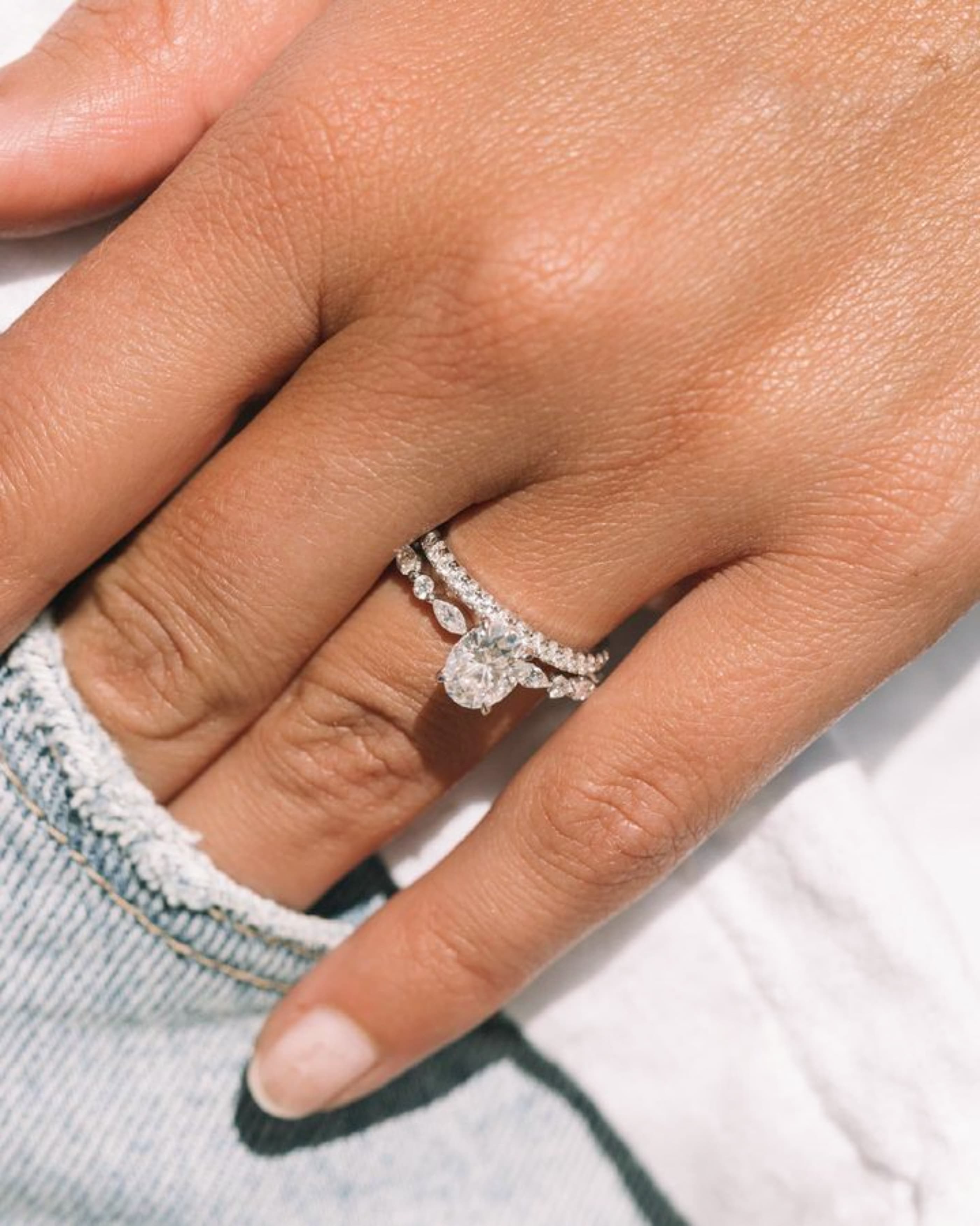 A slim yellow gold pavé-set wedding band with a line of tiny diamonds along the top